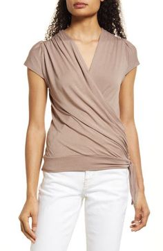 A faux-wrap front flatters on this soft and versatile jersey top cinched with a saucy tie at the hip. 23 1/2" length Surplice V-neck Short sleeves 95% rayon, 5% spandex Machine wash, dry flat Imported Women's Clothing What To Wear In Paris, Satin Wrap Top, Wrap Front Top, Fall Wardrobe Essentials, Faux Wrap Top, Wrap Shirt, Oui Oui, Jersey Top, Wrap Top