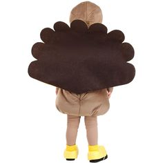 a child in a turkey costume is standing with his back to the camera