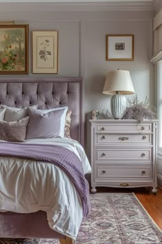 a bed sitting in a bedroom next to a dresser and window with pictures on the wall