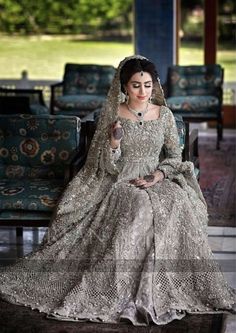 a woman in a wedding dress sitting on a couch