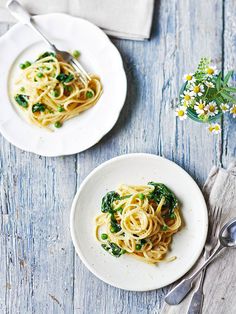 two plates of pasta with spinach and cheese