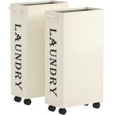 two white laundry bins with black lettering on the front and bottom, sitting side by side