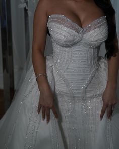 a woman in a wedding dress posing for the camera