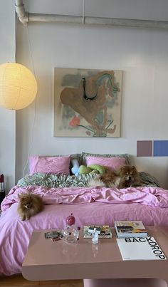 a dog laying on top of a pink bed in a bedroom