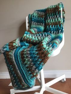 a crocheted scarf is sitting on a mannequin