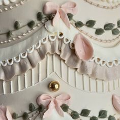 a wedding cake decorated with pink flowers and green leaves