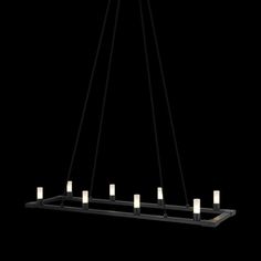 a black chandelier with candles hanging from it