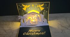 an illuminated christmas card with the nativity scene on it's front and side