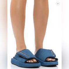 The Azalea Wang Calico Slip On Sandal In Blue Denim Is Made From A Light Denim Upper And Features A Wide, Cushioned Foot Band With Velcro Closure, A Non-Functional Decorative Zipper Detail, A Vegan Leather Insole, A Slip-On Fit, And A Ridged Flatform Sole. *Denim Upper *Open Almond Toe *Flatform Sole *1” Flatform Sole Height Azalea Wang, Shoes Blue, Light Denim, Zipper Detail, Blue Shoes, Slip On Sandal, Women's Shoes Sandals, Vegan Leather, Blue Denim