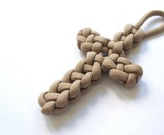 a cross made out of rope on a white surface