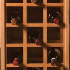 a wooden wine rack with many bottles in it