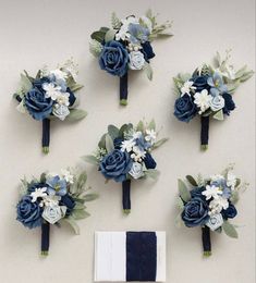 wedding bouquets and boutonnieres laid out on a table