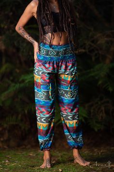 These tribal, bohemian-style pants are super soft and comfy! If your wish is freedom, your wish is these pants command! The Tribal Yoga Ali Baba Pants are light and breathable so they are ideal for yoga. They have elastic ends so they can be shortened for extra styling. In these pants, you can jump, twist, bounce, and be wild! CHECK THIS VIDEO OF A YOGA SESSION WITH THE PANTS : https://www.instagram.com/p/BPG46ZigA-P/ Material : 100% CottonMEASUREMENTS :Length:38.5 inches / 98cmWaist: 23.5 inche Casual Boho Print Pants For Festivals, Casual Boho Print Festival Pants, Stretch Harem Pants For Festivals, Multicolor Bohemian Pants With Boho Print, Multicolor Ankle-length Harem Pants With Elastic Waistband, Bohemian Festival Bottoms With Elastic Waistband, Stretch Hippie Pants For Festivals, Bohemian Yoga Pants For Summer Meditation, Hippie Style Long Yoga Pants For Meditation