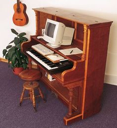 an old piano with a computer on it