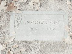 the headstone of unknown girl is surrounded by dead leaves