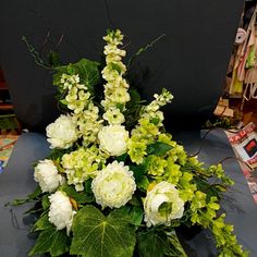 a bouquet of white and green flowers on a table