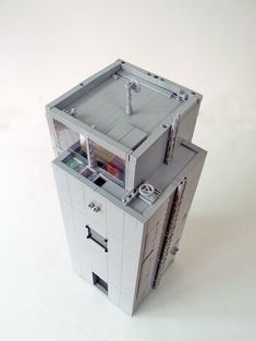 a lego model of a storage unit with doors open and shelves on each side, in front of a white background