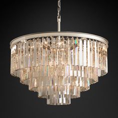 Inspired by the Art Deco style of 1920s Paris, the collection captures the period's fascination with geometric forms. Masterfully refracting the light, hundreds of faceted, dynamic prisms evoke the allure of the era. Hanging like lush fringe from a welded iron frame, the angular glass juxtaposes elegance and industrialism. Dimension: Chandelier Body: 31½" diam., 26"H Canopy: 5¾" diam., 3½"H Chain: 72'L Cord: 12'L Weight: 145 lbs. Notes: If different sizes, finishes, or extra chain length are nee Luxury Cookware, Living Room Pendant Light, Nordic Chandelier, Tier Chandelier, Crystal Chandelier Lighting, Luxury Chandelier, Round Chandelier, Geometric Forms, Candelabra Bulbs