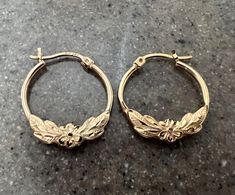 Gorgeous hoop earrings made of solid 10K gold with a floral design ...these well made earrings are hollow and weigh a total of 1.3 grams...and measure 15/16" long ...these are exquisite earrings.  Stamped 10K on the posts of the earrings. In fairly good condition. The hoop on the right has a dent. See the last two pics. Will ship in a gift box. Stock # S750 As with all jewelers, I do enlarge pictures of the jewelry.  This is to your advantage, so you can see all details more clearly.  I do provi Flower Shaped Hoop Earrings For Anniversary, Gold Flower Hoop Earrings For Anniversary, Flower Hoop Earrings, Gold Flower, Jewelry Earrings Hoops, Gold Flowers, Tape Measure, 10k Gold, Ruler