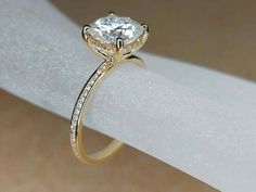 a diamond ring on top of a white napkin