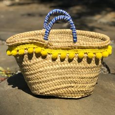 When life gives you lemons 🍋, make sure they’re Sicilian! Or make a typical Sicilian style bag called a “coffa”. This is a bag coming from the ancient rural Sicilian tradition. “Coffa” means basket in Sicilian. The coffa was the ancient straw basket used by peasants to feed their horses and donkeys, and nowadays it’s an icon in Sicilian fashion. Bag is adorned with a yellow pom pom trim and beaded lemon patches. Handles are wrapped in blue gingham.Opening Width: 13" Height: 7" Sicilian Fashion, Sicilian Style, Sicilian Lemon, Basket Uses, Straw Basket, Pom Pom Trim, Donkeys, Blue Gingham, A Bag