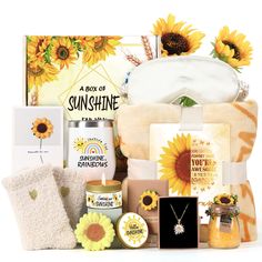 sunflowers and other items are arranged in the shape of a gift box with a greeting card