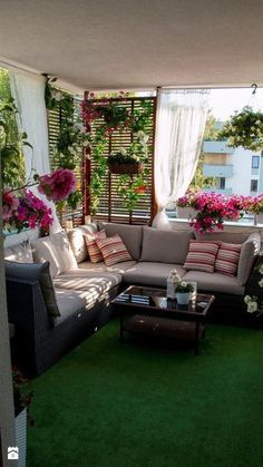 a living room filled with lots of furniture on top of a green floor covered in flowers