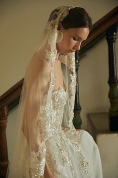 a woman wearing a wedding dress and veil