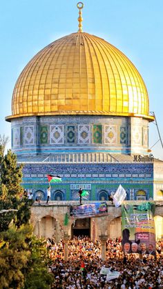 the dome of the rock is shown with many people around it in front of it