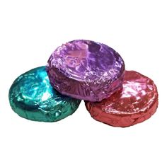 three foil wrapped chocolates sitting on top of each other