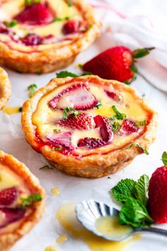 several small pies with strawberries on them