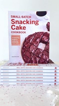 the small batch snacking cake cookbook is stacked on top of each other,