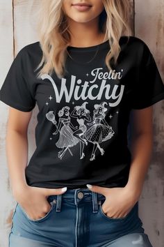 Feelin' Witchy, Halloween Graphic TopHalloween, Witch, Magic,This item is made entirely from eco-friendly materials. It has a unisex fit that is true to size, with a crew neck and short sleeves. The shirt is crafted from superior combed and ring-spun cotton, with a 32 single 4.2 oz. Weight. It is side-seamed and has a retail fit, with shoulder taping for added comfort. The print is created using high-quality water-based ink, which is eco-friendly and leaves a soft touch on the fabric.Made In: Ma Witchy Halloween, Halloween Festivities, Knitted Swimsuit, Halloween Graphic Tees, Halloween Graphic, Denim Short Dresses, Witch Magic, Color Wow, Graphic Top