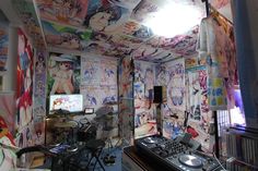 a room that has various wallpapers and dj equipment on the floor in front of it