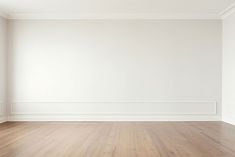 an empty room with hard wood floors and white walls