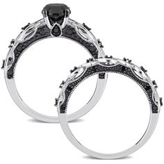 two wedding rings with black diamonds on each side and an engagement ring in the middle