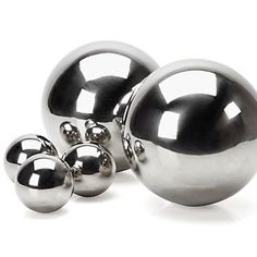 three metal balls are shown on a white background