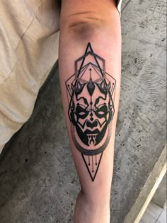 a man with a tattoo on his leg has a darth vader face in the center