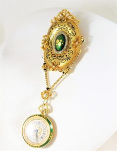 Luxury Yellow Gold Pendant Brooch, Luxury Gold Brooches With Cabochon, Victorian Yellow Gold Pocket Watch For Anniversary, Elegant Yellow Gold Medallion Brooches, Luxury Cameo Brooches, Luxury Yellow Gold Cameo Brooch, Elegant Hallmarked Pocket Watch For Collectors, Ceremonial Gold Brooches With 17 Jewels, Luxury Gold Engraved Pocket Watch