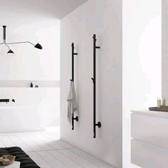 a white bathroom with black accents and fixtures