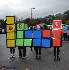 some people are standing in a parking lot with rubik cubes on their backs