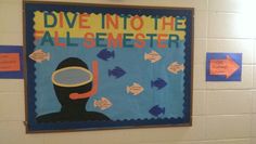 a bulletin board on the wall in a classroom with fish and diver's mask