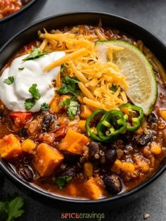 two black bowls filled with chili and tofu