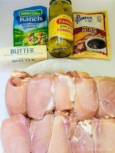 raw chicken and other ingredients laid out on a counter