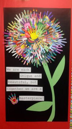 a bulletin board with some writing on it and a flower made out of crayons