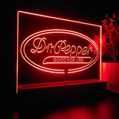 a neon sign that says dr pepper's good for life in red light on a black background