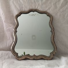 a mirror sitting on top of a white sheet