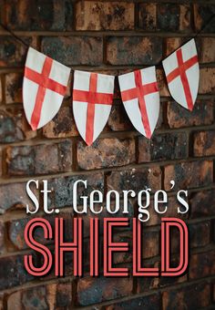 a brick wall with red and white flags hanging from it's sides that says, st george's shield