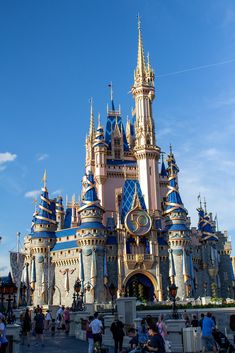 people are standing in front of a castle with blue and gold paint on it's walls