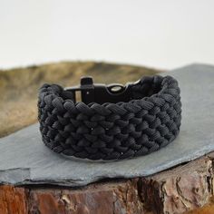 "This bracelet is the 'Conquistador Weave Design' and features a flint fire starter whistle buckle. The approximate width is 30mm. As well as being very decorative and stylish, these bracelets - when unravelled in an emergency or survival situation - will give you a large amount of high quality military grade paracord. The amount will depend on the size of your wrist, but for example: an 8 inch bracelet will provide you with approximately 15 foot of cord. A must have for all soldiers, scouts, walkers, campers, cyclists and climbers, or just a good looking stylish bracelet! All my bracelets are handmade to order in the UK and I aim to supply you as quickly as possible with a high quality bracelet. Follow the instructions below on how to measure your wrist: 1) To measure your wrist size you Black Outdoor Bracelet Jewelry, Durable Paracord Bracelets For Outdoor, Adjustable Black Paracord Braided Bracelet, Black Bracelet Jewelry For Outdoor, Handmade Black Braided Bracelets For Outdoor, Durable Black Paracord Bracelets, Adjustable Black Bracelets For Outdoor, Adjustable Black Braided Bracelet For Outdoor, Adjustable Black Braided Bracelet